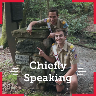 The National Chief Zach Schonfeld and National Vice Chief Noah Smith pointing to a rock with "Quapaw Little Rock, AR". The overlying text says chiefly speaking.