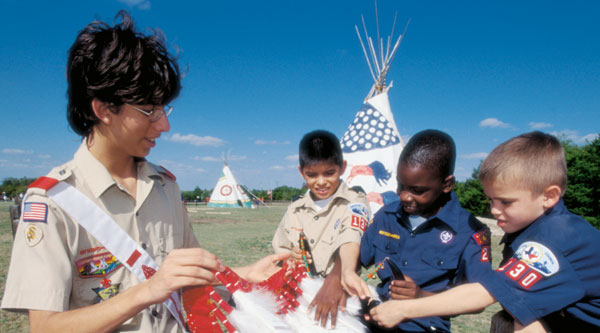 Arrowman teaching Cub Scouts