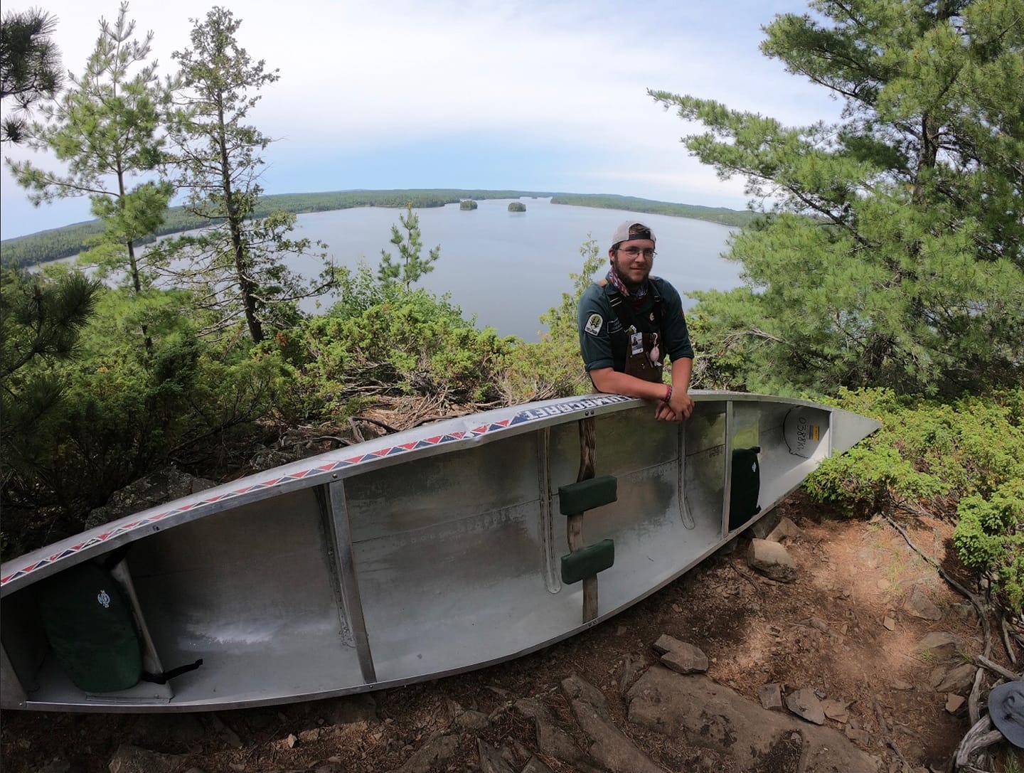 Sam Rogers leaning on a canoe during his trek with OAWV