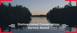 Scenic view of water and trees. The overlying text says Distingished Conservation Service Award
